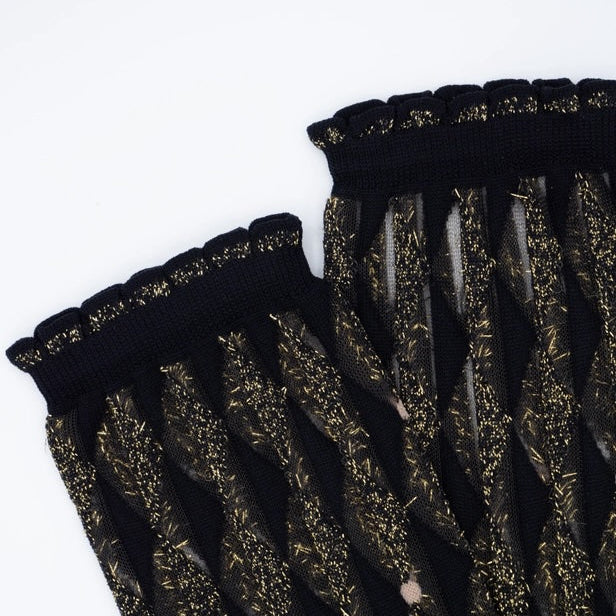 top part of a pair of Sheer socks with a geometric pattern black and gold