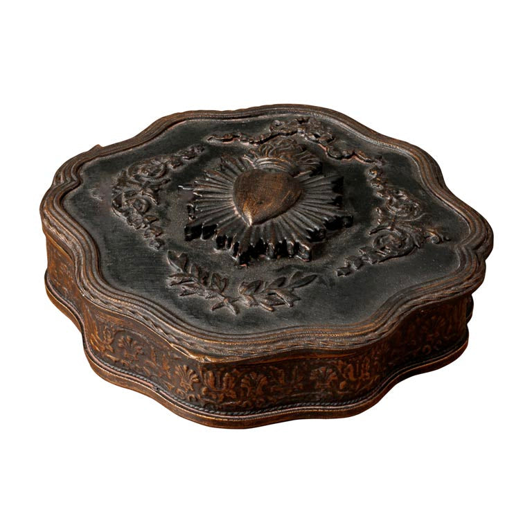 Decorative wooden box with intricate carvings on a white background