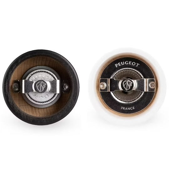 Two Peugeot pepper mill seen from under on a white background