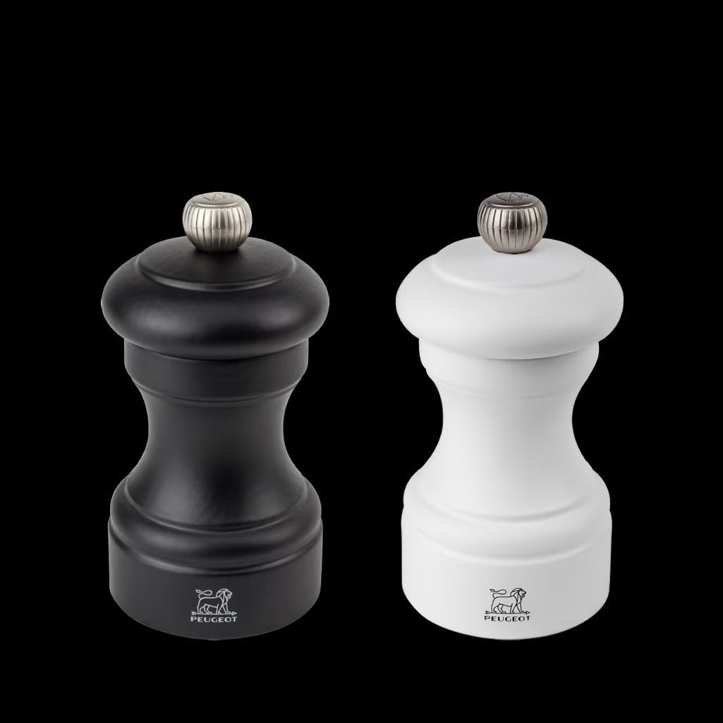 Black and white pepper mills with Peugeot logo on a white background