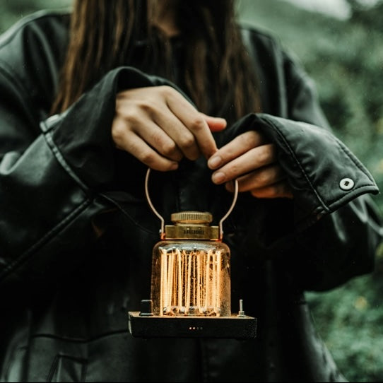 Person holding a lantern with a blurred background