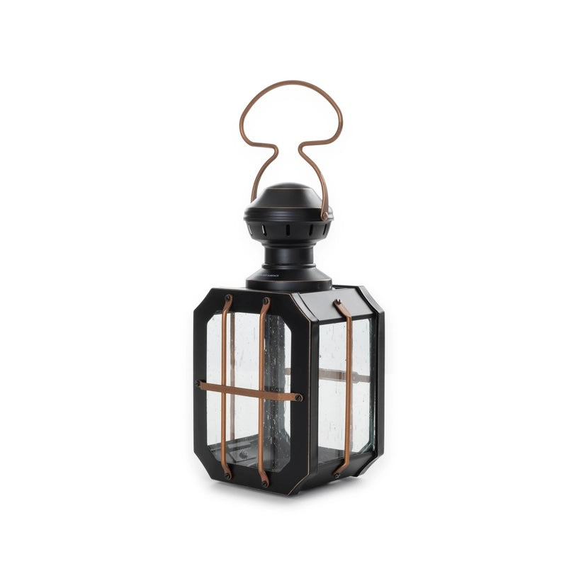 Black lantern with clear glass panels and copper accents on a white background