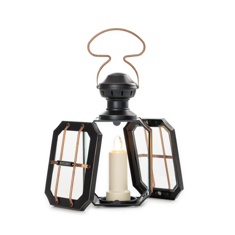 Black lantern with a candle inside on a white background