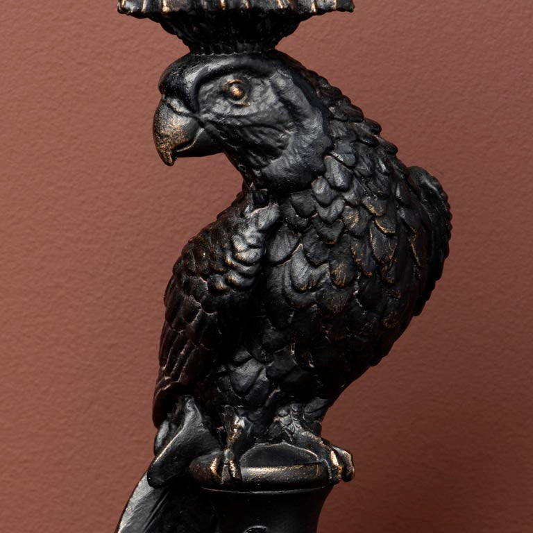 Decorative candle holder shaped like a parrot on a brown background