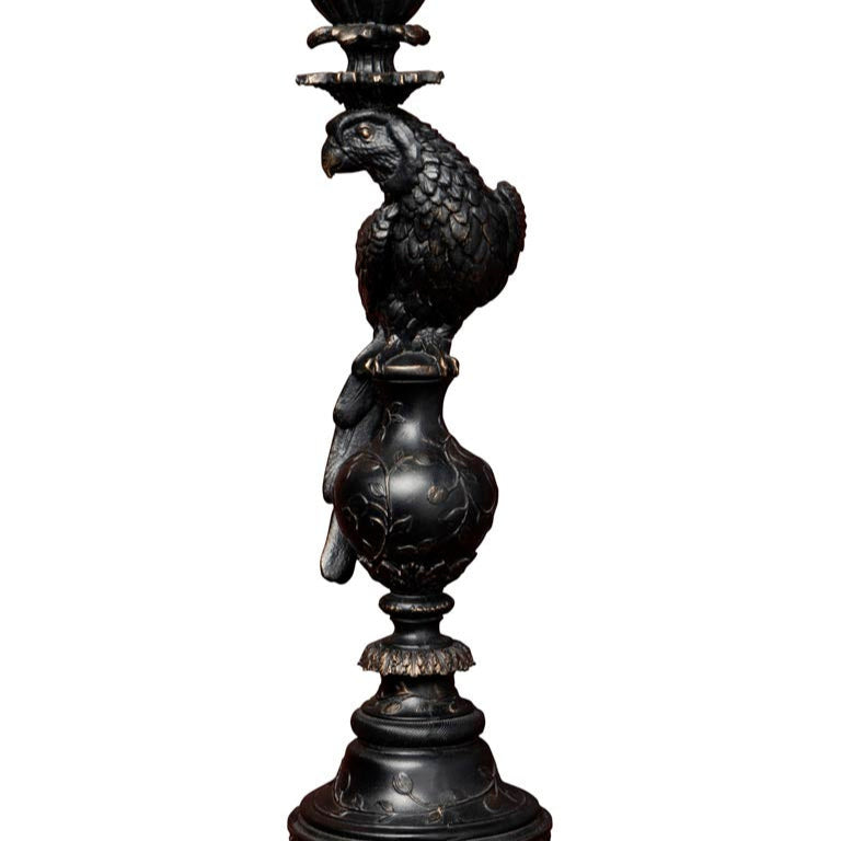 Decorative black metal candle holder with parrot design on a white background