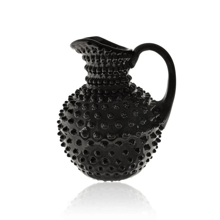 Black textured pitcher on a white background