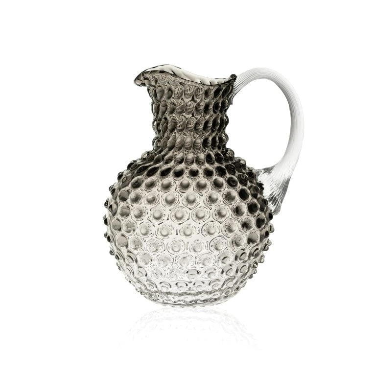 Black smoke ombre glass pitcher with textured surface on a white background