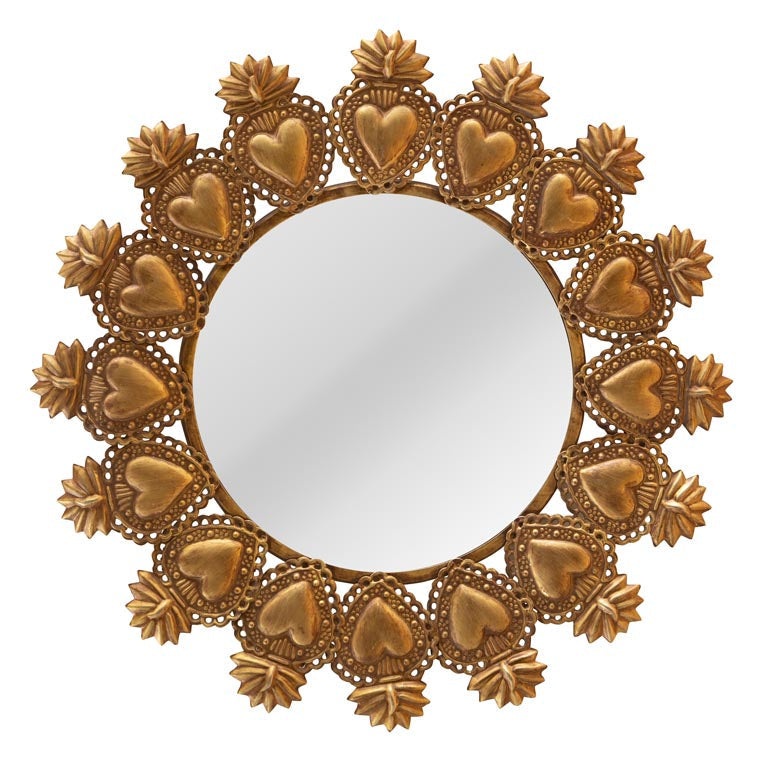 Decorative gold mirror with heart and floral patterns on a white background
