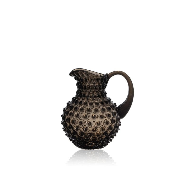 Black smoke Decorative glass pitcher with textured surface on a white background