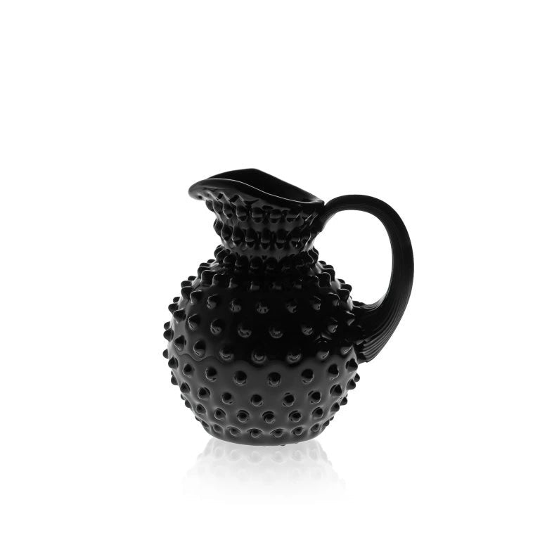 Black glass textured pitcher on a white background