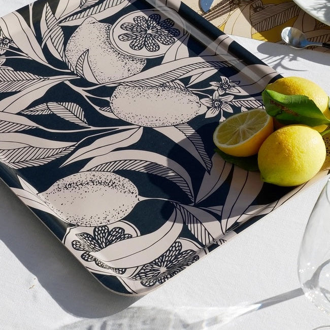 Decorative tray with floral pattern on a table with lemons
