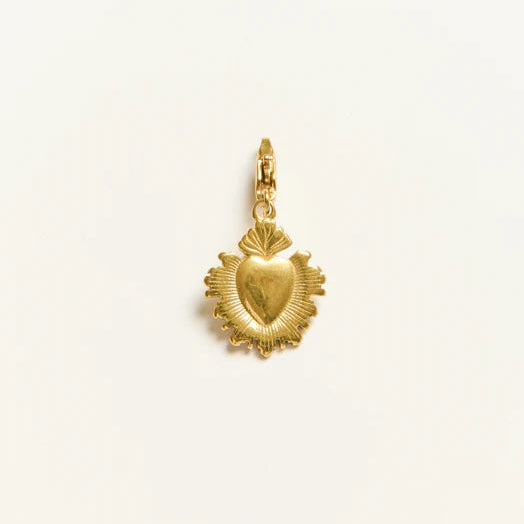 Gold heart-shaped pendant on a light beige background