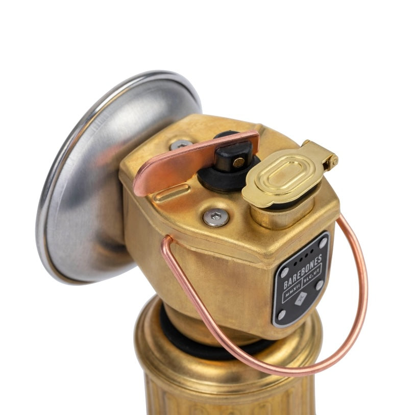 Close-up of a brass valve with copper wiring on a white background