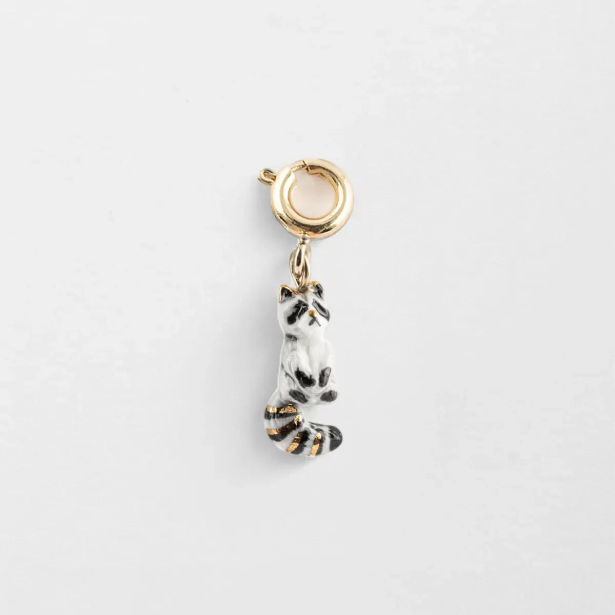 Raccoon-shaped charm on a white background
