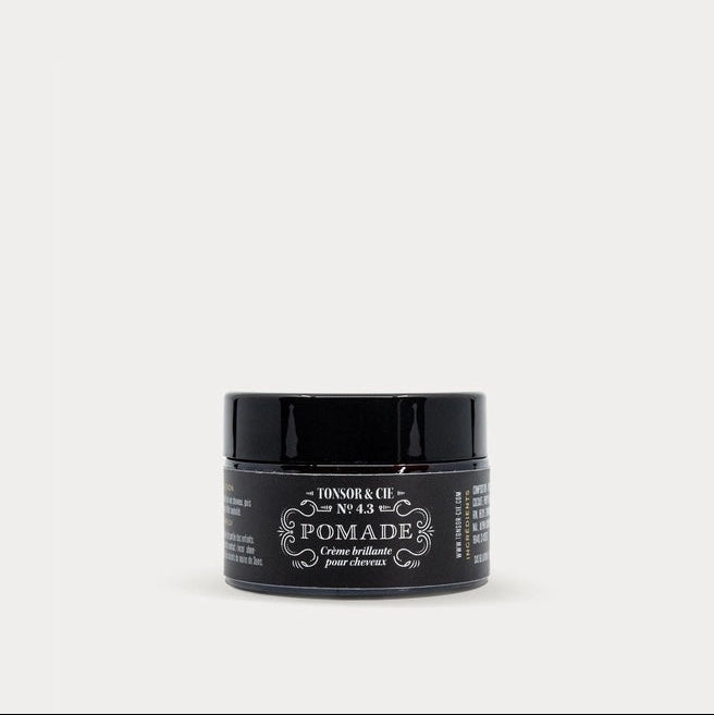 Jar of pomade with a black label on a white background