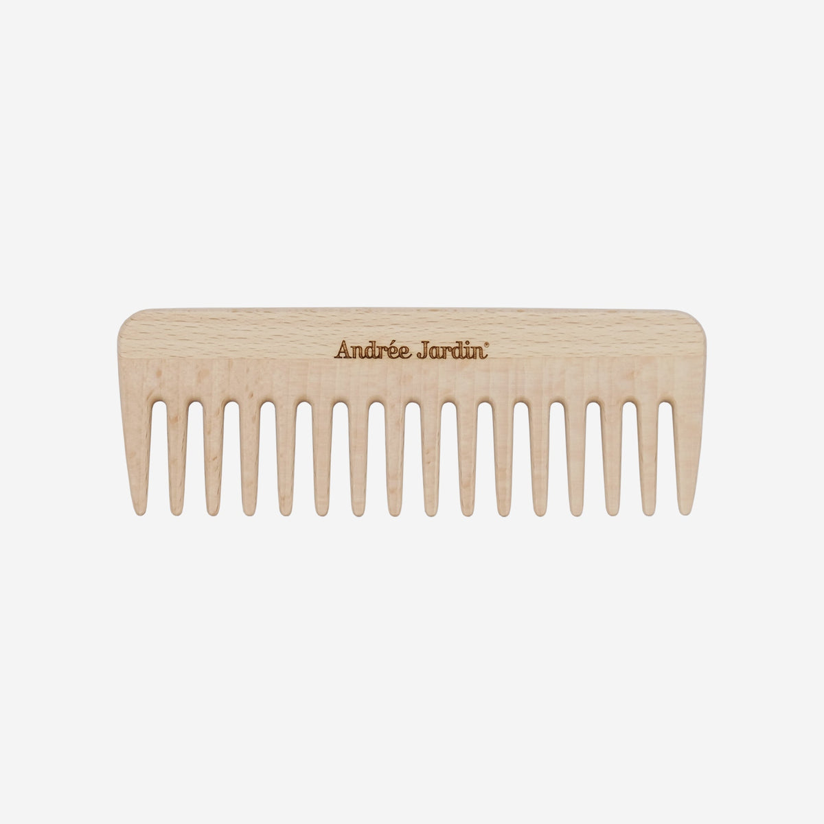 Blonde wooden comb with widely spaced teeth, shown flat against a plain background – Andrée Jardin
