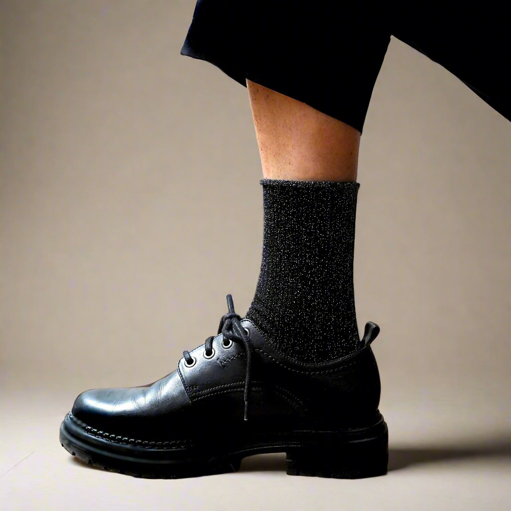 Black glitter socks worn with polished black lace-up derbies – KLUE