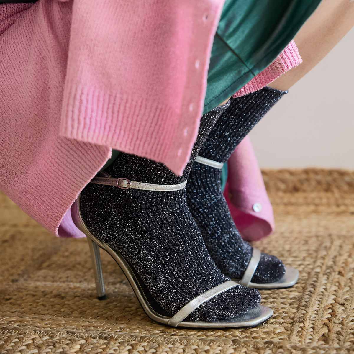 Grey glitter socks styled with silver strappy heels and a pink knit – KLUE