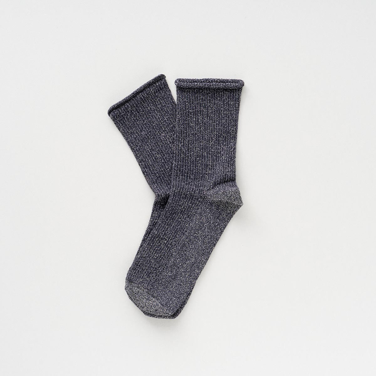 Charcoal grey socks with a silver lurex shimmer, laid flat to show the rolled cuffs – KLUE