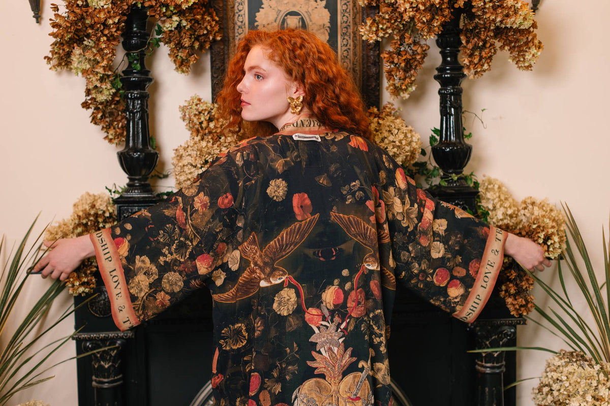 Wide view of the black kimono's wing-like sleeves and sacred heart back print – Market of Stars