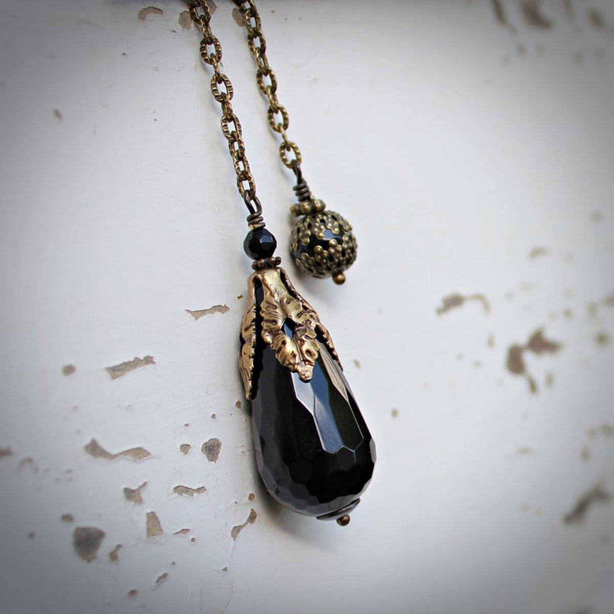 Faceted black onyx pendulum shown full length – Circa 1890