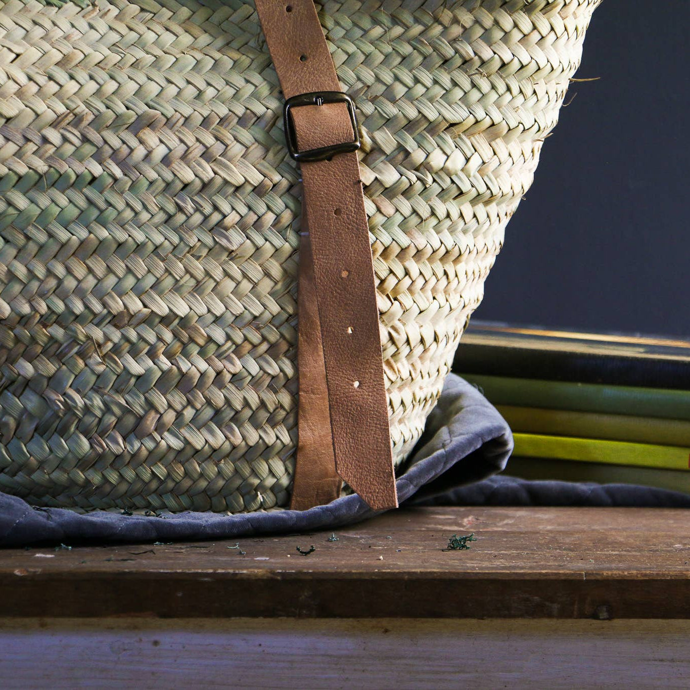 Detail of the brass buckles fastening the leather straps to the woven palm basket – Medina