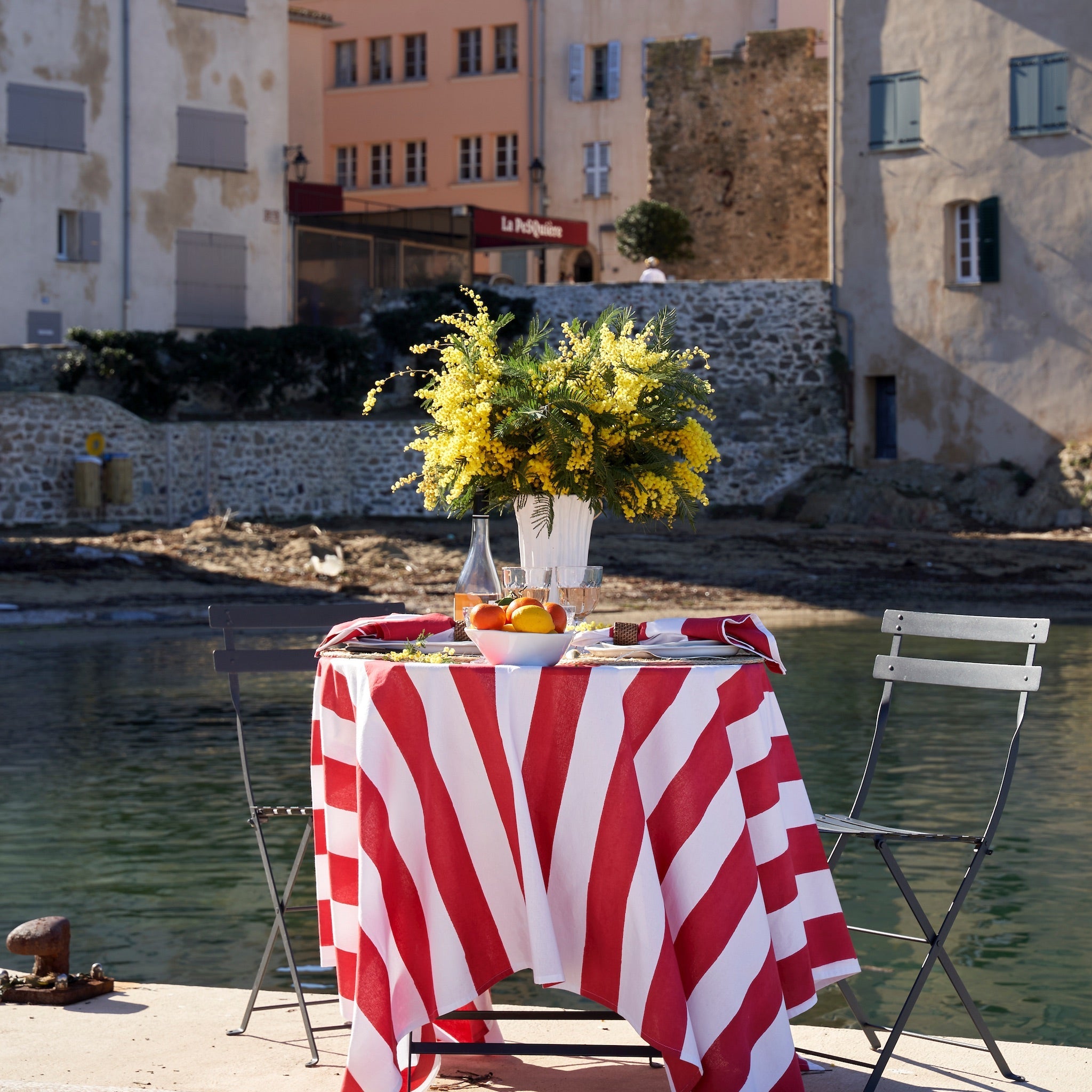St. Tropez Red Stripes tablecloth on a table by the harbour – Caravan Home