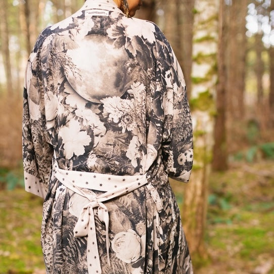 Back of a monochrome floral kimono robe with tied sash among birch trees – Market of Stars