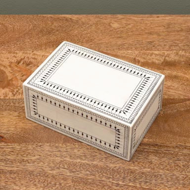 Decorative box with intricate patterns on a wooden surface