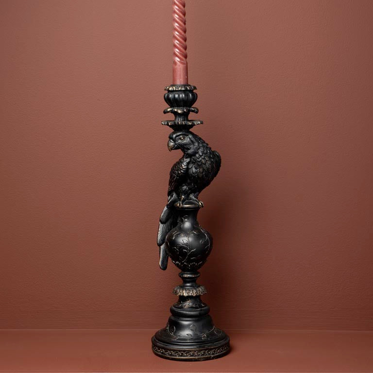 Decorative candle holder with a candle on a brown background