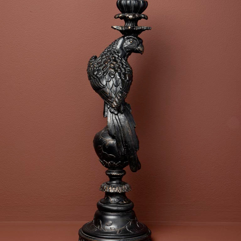Decorative black resin candle holder with a parrot
 on a brown background