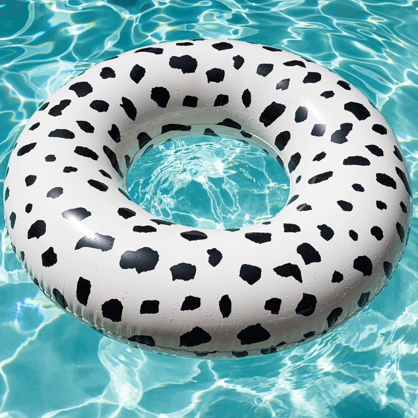 Inflatable pool ring with black and white Cheetah pattern on a pool background