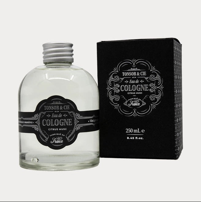 Cologne bottle with black label and packaging on a white background