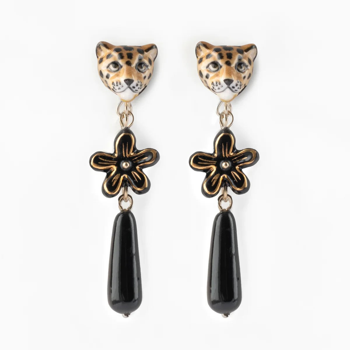 A pair of dangling earrings featuring leopard head studs with black spots, connected by gold-tone chains to black flower charms and long black teardrop pendants, shown on a plain white background.