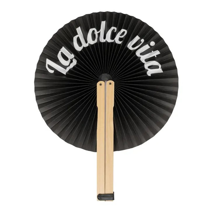Black paper fan with 'La dolce vita' text on a white background