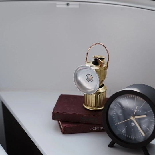 Small lamp and clock on a white surface