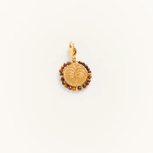 Gold pendant with a leaf design on a white background