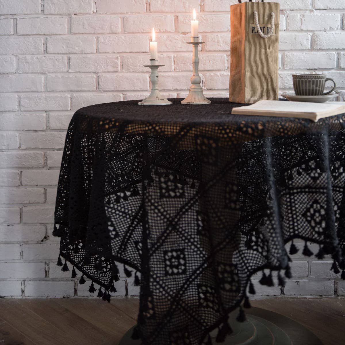 Close-up of the black crochet rosette medallions and tassel fringe on the cotton tablecloth – ACCITY