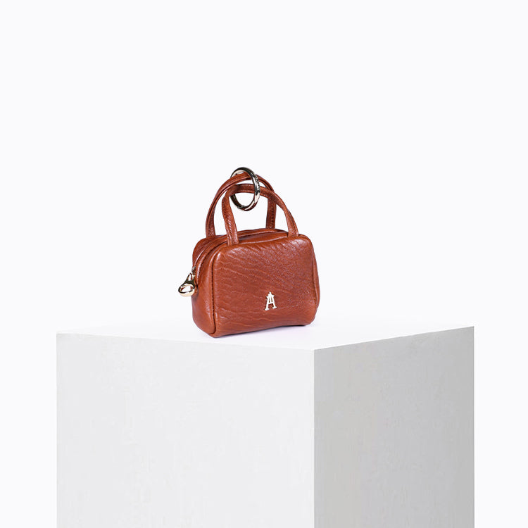 Brick-rust bubble leather mini pouch shown from the side – Craie Studio
