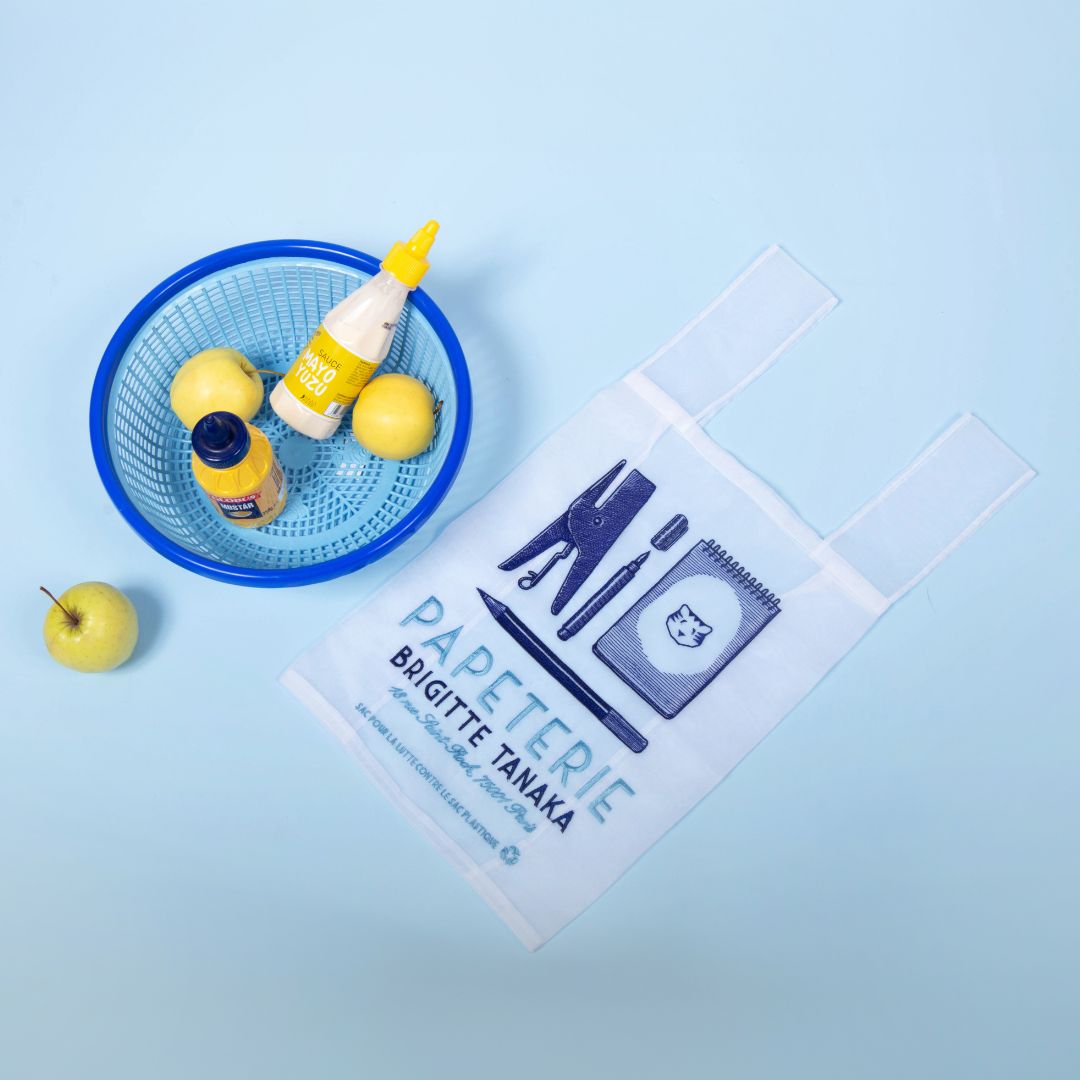 Papeterie organza bag laid on blue beside a bowl of lemons – Brigitte Tanaka