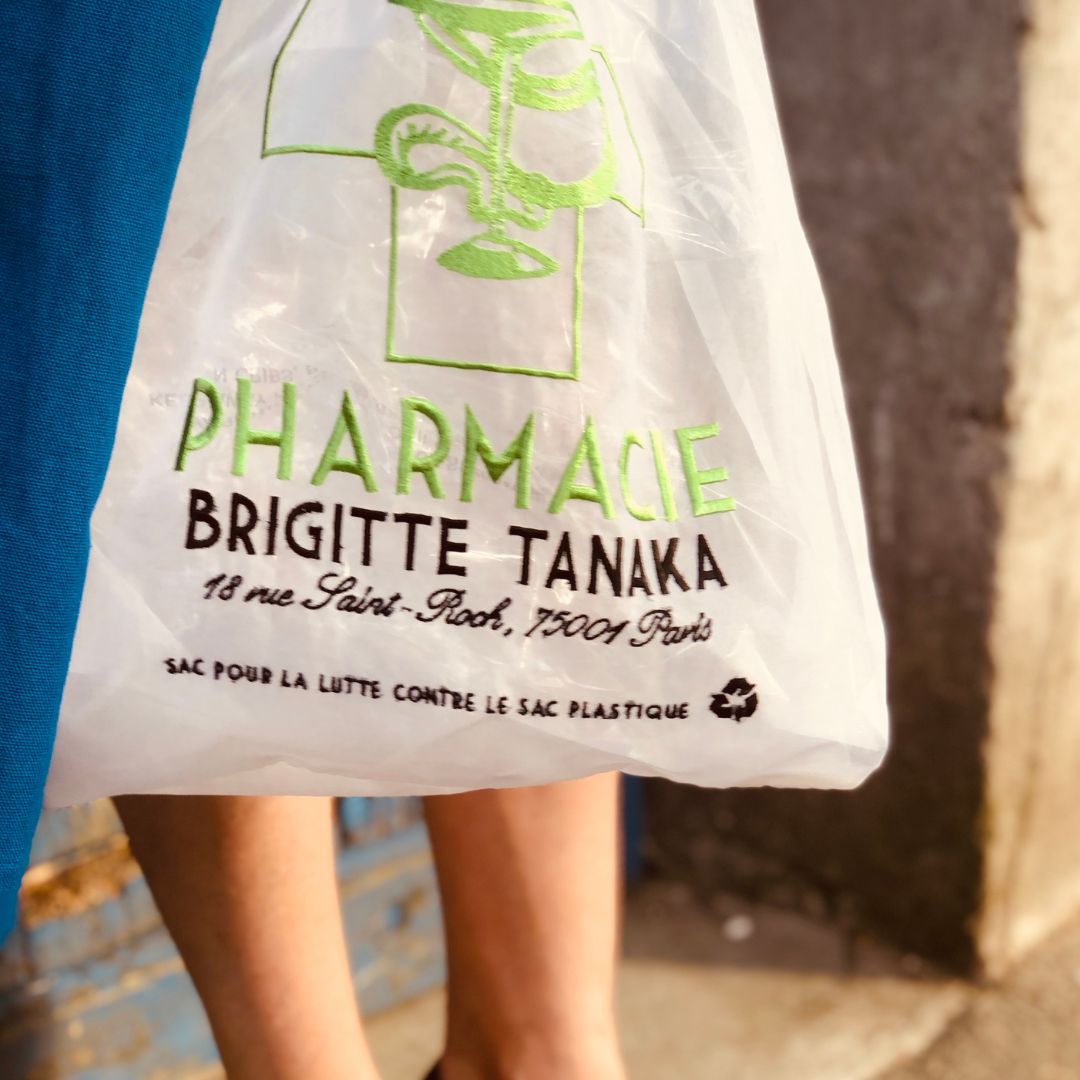 Close-up of the green Pharmacie embroidery and shop-sign lettering – Brigitte Tanaka