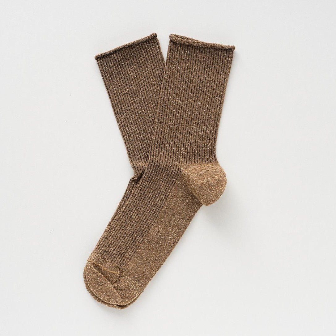 Caramel socks with a golden glitter, laid flat to show the rolled cuffs – KLUE