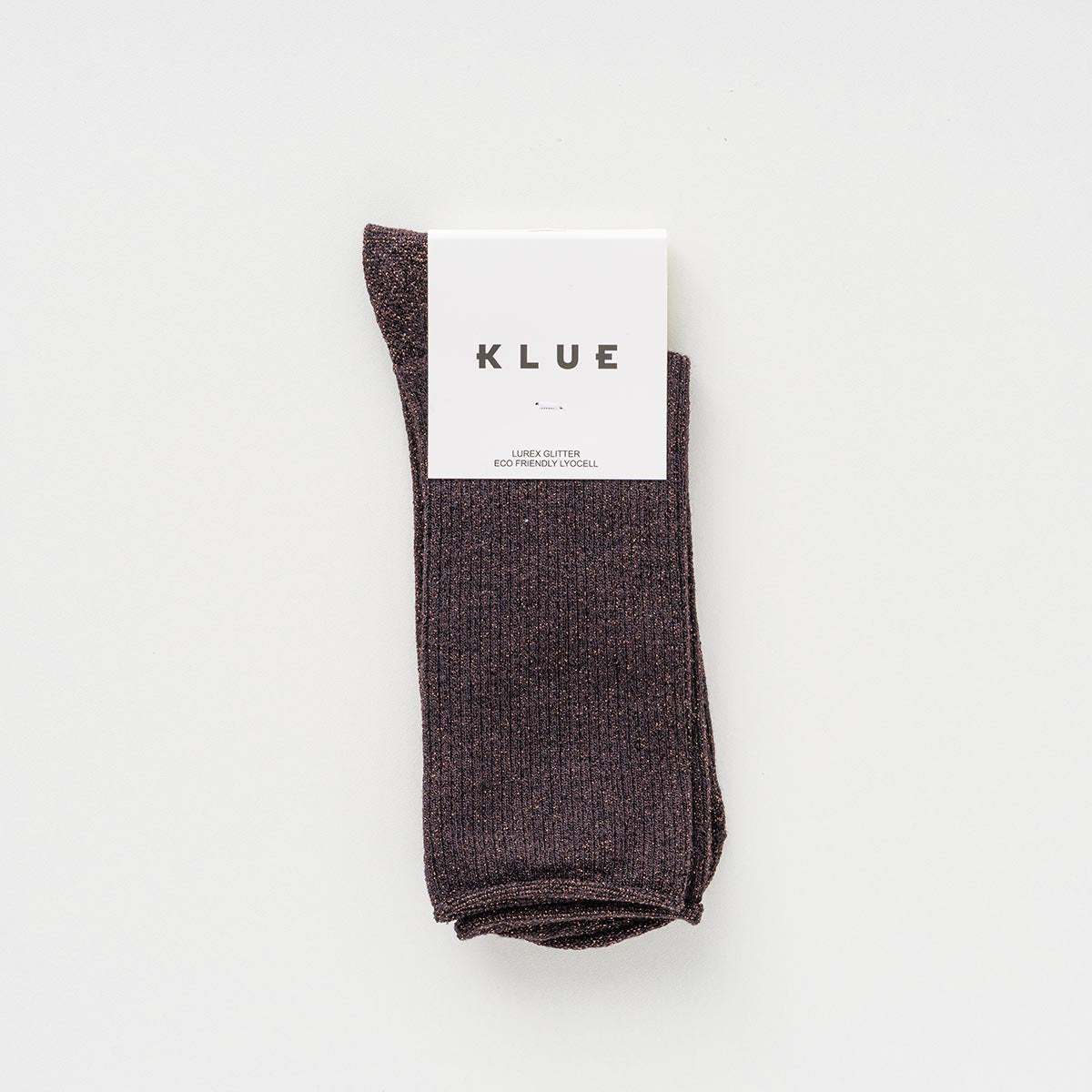 Folded pair of dark chocolate brown socks with a subtle shimmer in a KLUE paper band – KLUE