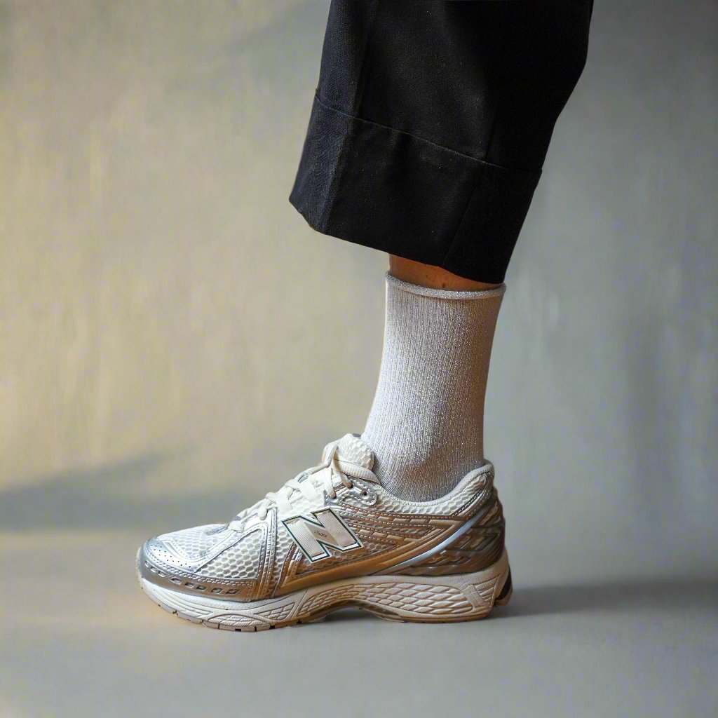 White sparkly socks worn with silver trainers and black trousers – KLUE