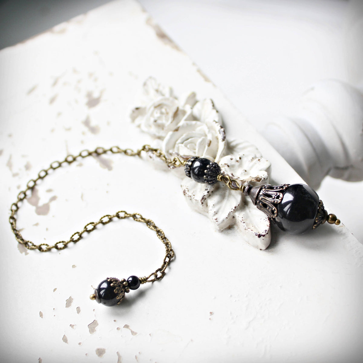 Black agate and onyx dowsing pendulum shown full length – Circa 1890