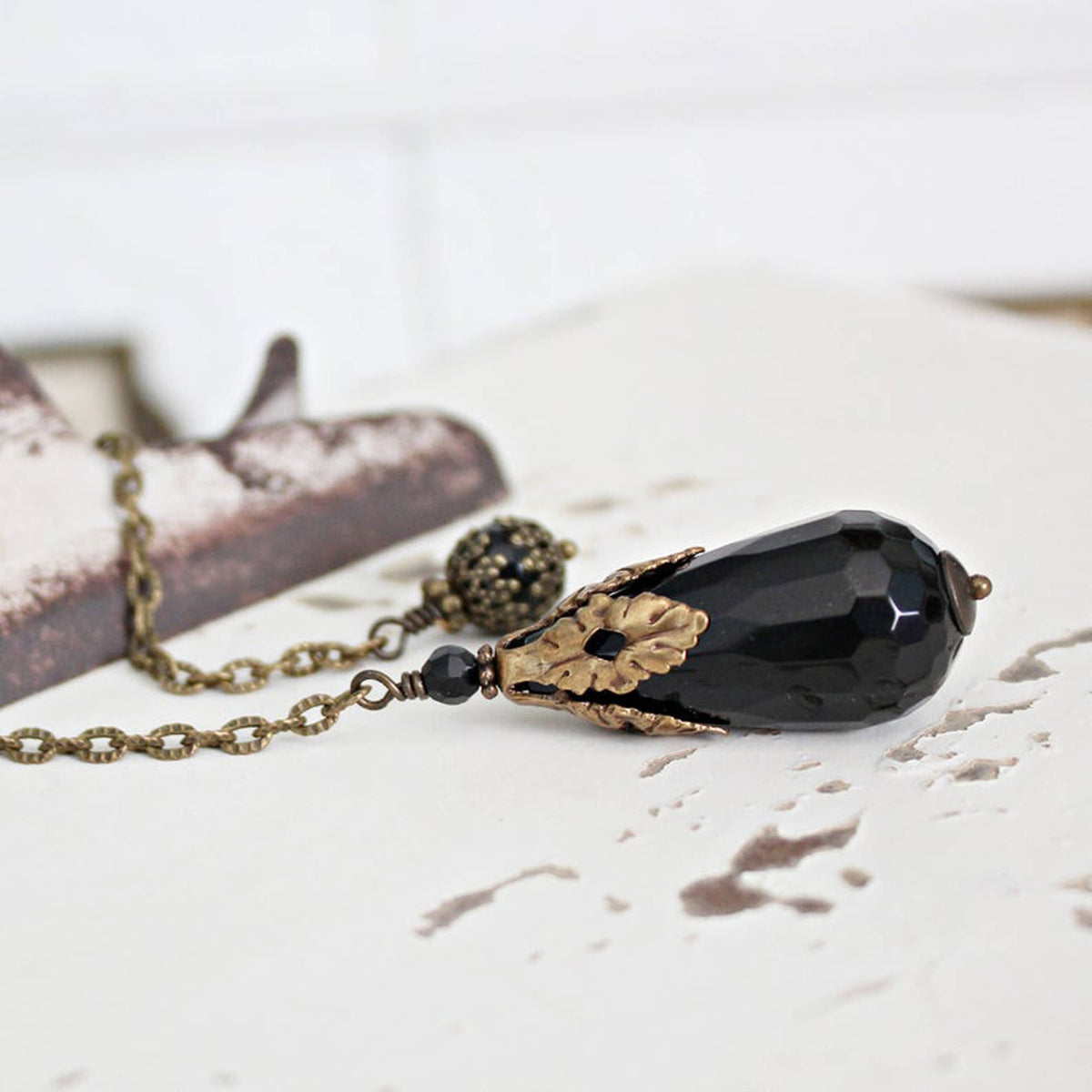 Faceted black onyx pendulum point on an antique-gold chain – Circa 1890
