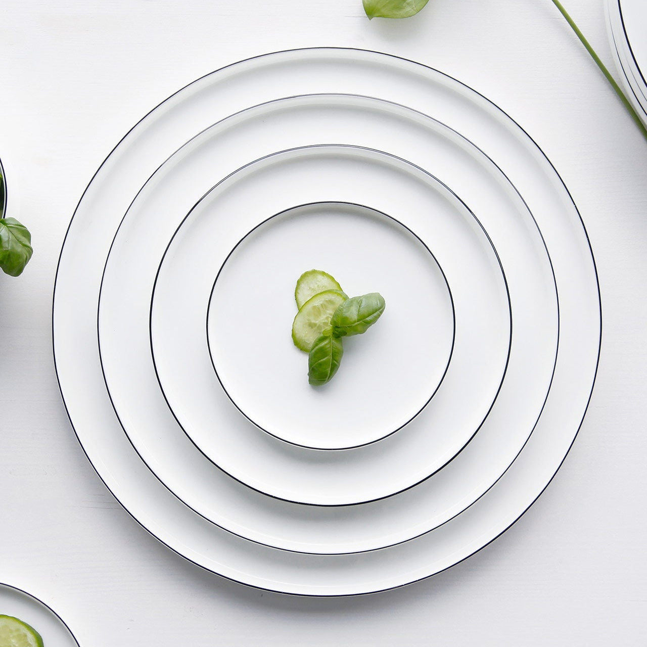OCO Ligne Noire plates nested by size on a table – ASA Selection