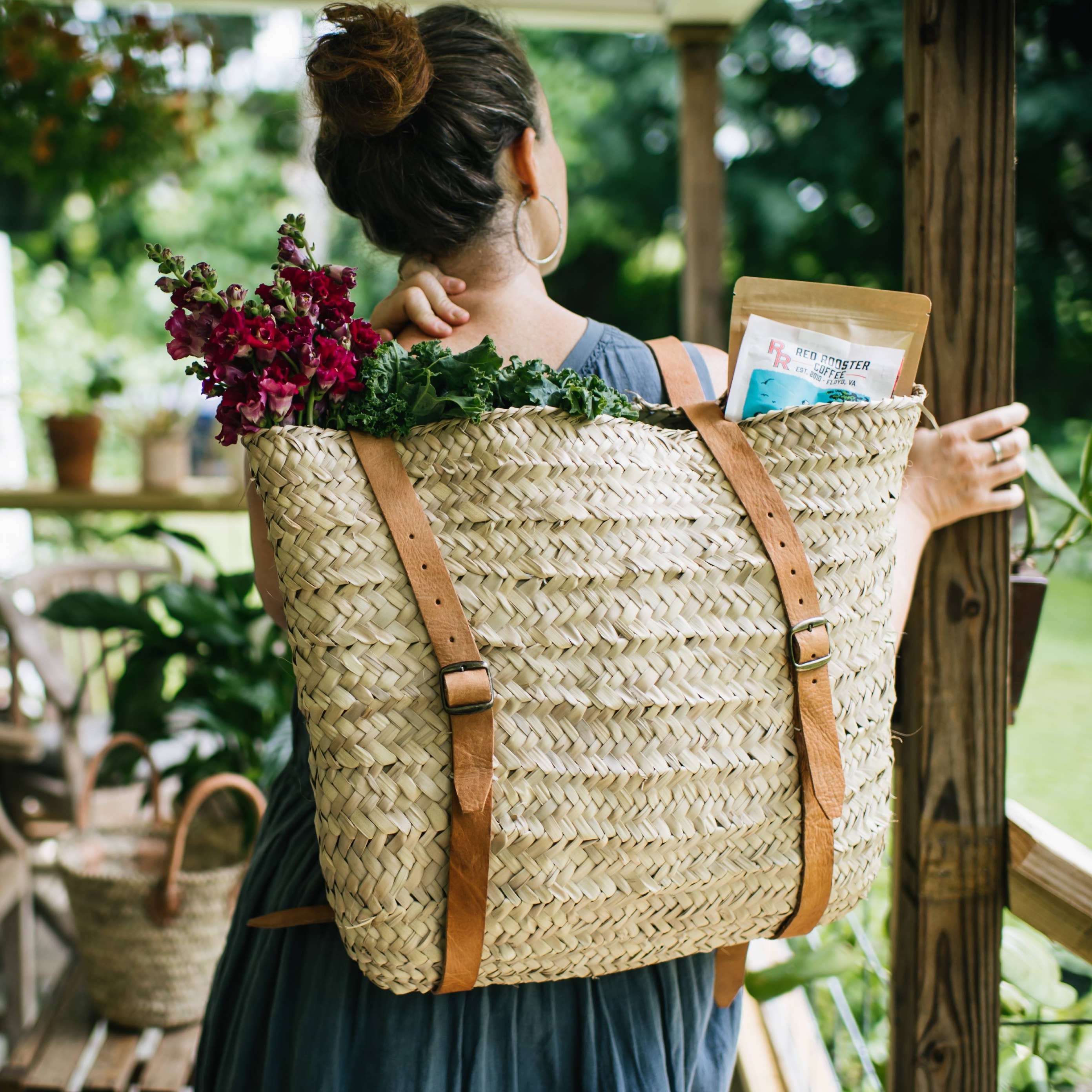 Woman wearing the woven palm leaf basket as a backpack, filled with flowers and greens – Medina