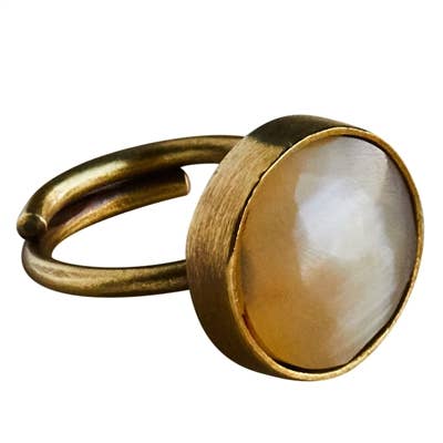 Gold ring with a white stone on a white background