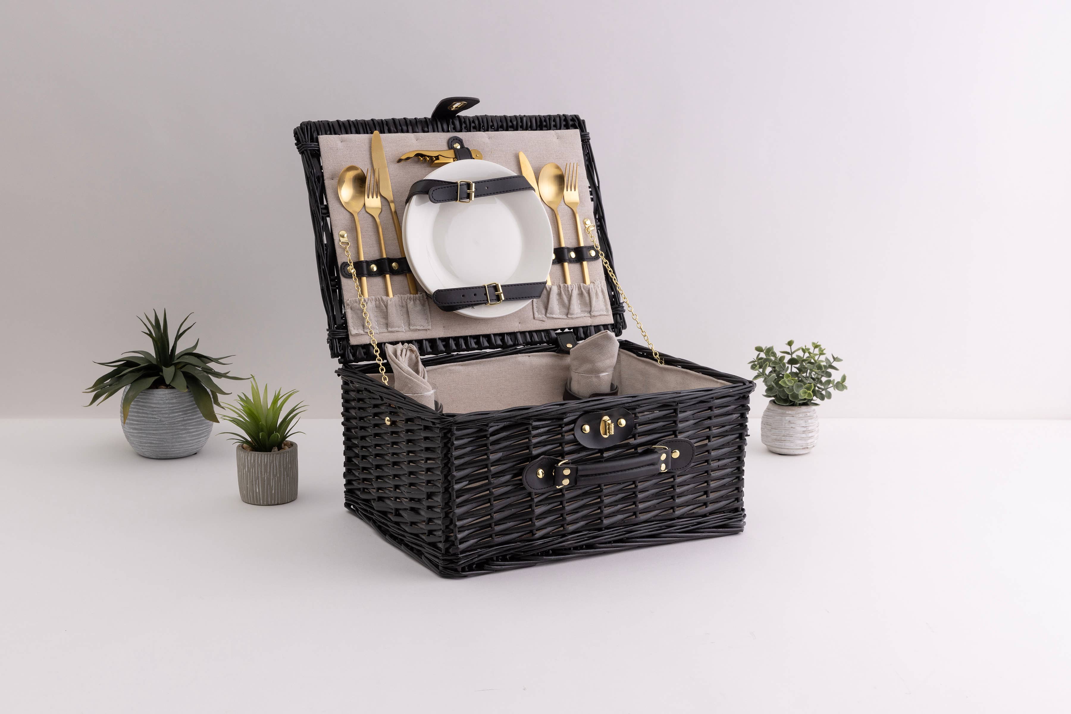 Black willow picnic basket for two open in a styled interior scene - Picnic Time